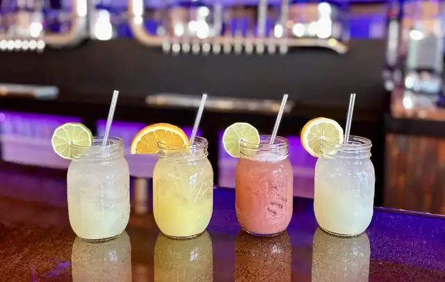 House cocktails lined up on the bar