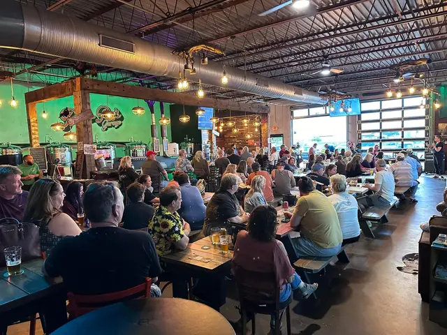 Groups at picnic tables inside the brewery