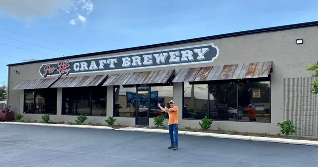 Standing proud in front of the Craft Brewery sign