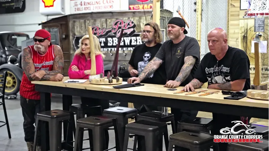The Orange County Choppers crew at the Pee-Pa's Garage bar with axe throwing gear on the table